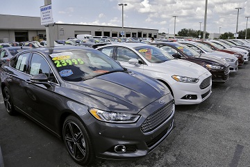 A car salesman works the telephone while searching through inventory at the certified used car lot at Brandon Ford in Brandon, Fla. on Tuesday, Nov. 3, 2015. Sales of new cars and trucks rose by double-digit percentages at most major automakers in October, and companies are raising their expectations for the rest of the year. Ford now expects total U.S. sales of 17.4 million this year, just topping the record of 17.35 million from 2001. (AP Photo/Chris O'Meara)